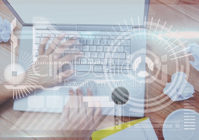 Hands of woman working on a laptop with digital graphics