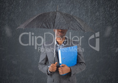 Business man under umbrella against in rain against grey background