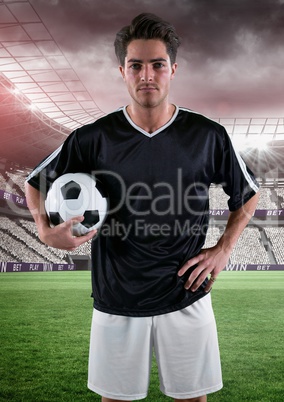 soccer player with the ball on his arm in the field