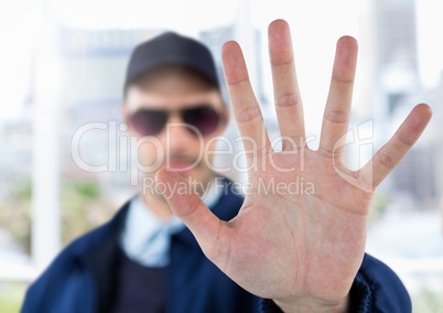 Security man outside with hand stop gesture