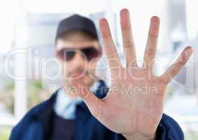 Security man outside with hand stop gesture