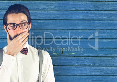 hipster with  the hand on the mouth  with blue wood background