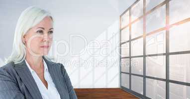 Old business woman looking across the windows