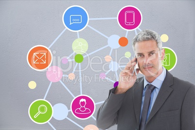 Businessman talking on phone in front of graphics
