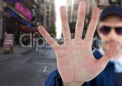 Man with stop hand gesture on street