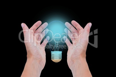 bulb on hands against black background