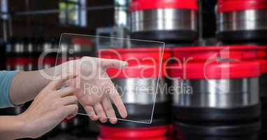 Hand photographing containers through transparent device at brewery