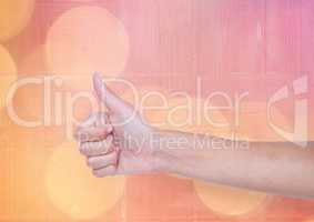 Hand thumbs up with sparkling light bokeh background