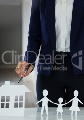 Cut outs of house and family with model in hall