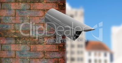 CCTV on a brick wall with the city in the foreground