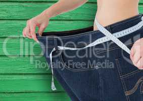 fitness woman big trousers with green wood background