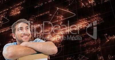 Digitally generated image of man looking at glowing mathematical equations