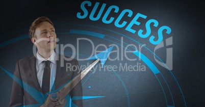 Digital composite image of businessman standing by success text with compass