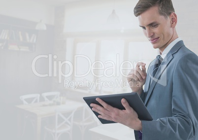 Businessman holding tablet in bright cafe restaurant