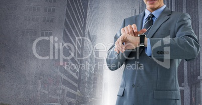 Businessman holding watch with city background