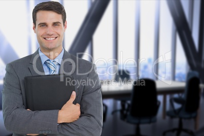 businessman holding a notebook against office background