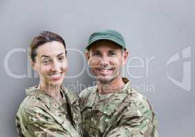 soldiers couple smiling. concrete wall