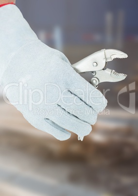 Hand with plier on building site