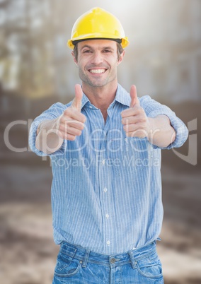 Construction Worker giving thumbs up in front of construction site