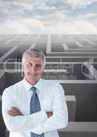 Portrait of confident businessman standing against maze