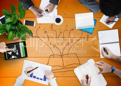 Overhead of business team with orange wood panel and book doodle