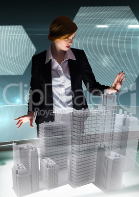 Young businesswoman in a futuristic room interface about city