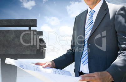 Architect holding a plan against the sky an a brigde