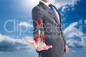 Businessman holding a rocket in his hands with blue sky background