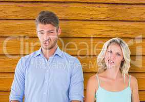 couple  funny faces with yellow wood background