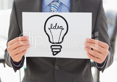 Grey lightbulb graphic on blank card held by business man mid section