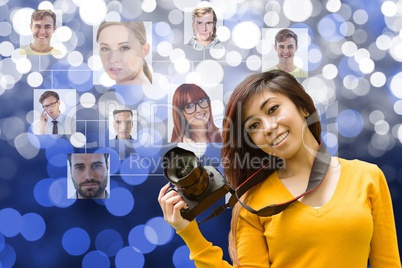 Young woman holding a camera in front of organization chart