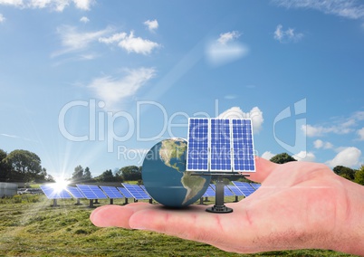 solar panel and earth on hand near the lake