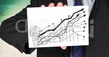 Business man mid section with card showing lightbulb and graph doodle against blurry green wood pane