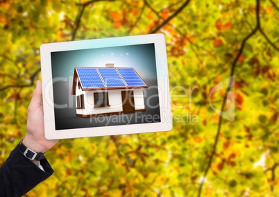 solar panel house on tablet with businesswoman hand in the park