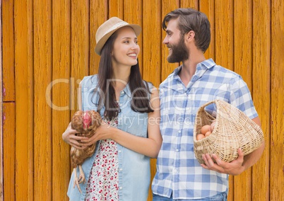 couple in the farm with yellow wood background