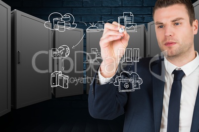 Businessman drawing ion the screen against server room background