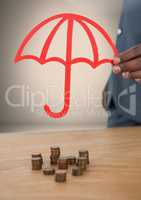 Cut out umbrella protecting money coins