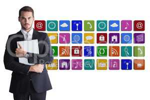 Businessman wearing a suit is holding notebook against application icon background
