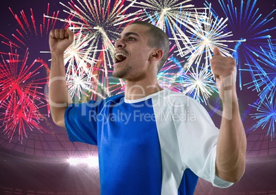soccer player wining, firework behind him