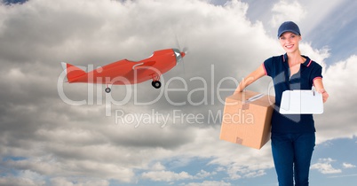 Digital image of female delivering parcel standing by airplane on sky
