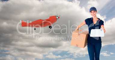 Digital image of female delivering parcel standing by airplane on sky