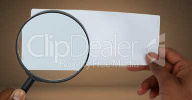 Magnifying glass looking at blank card