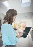 Businesswoman holding tablet at home