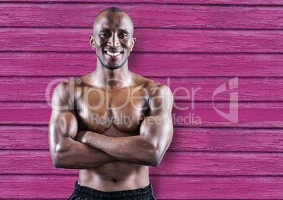 fitness man hands folded with pink wood background