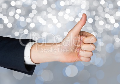 Hand Thumbs up with sparkling light bokeh background