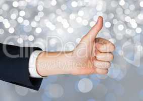 Hand Thumbs up with sparkling light bokeh background
