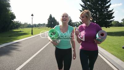 Pretty adult women going to training in the park