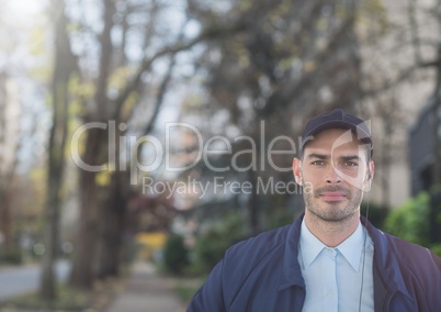 man with ear piece and hat security outside with trees