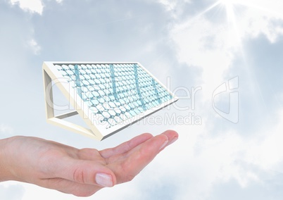 Digital image of hand with solar panel against sky