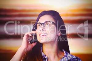 Composite image of close up of young woman talking on phone